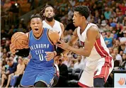  ??  ?? Russell Westbrook (left) of Oklahoma City Thunder drives past Josh Richardson of Miami Heat during their NBA clash on Tuesday. — AFP