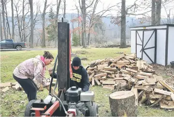  ??  ?? Jacey and Aaron Miller split wood on their property in Accident, Maryland. — WP-Bloomberg photos