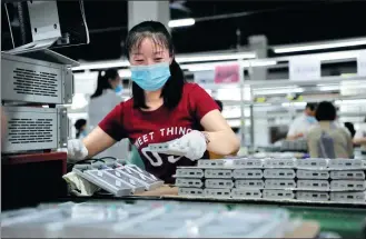  ?? ZHANG GUORONG / FOR CHINA DAILY ?? A technician works on the lithium battery production line of a new energy company in Yichang, Hubei province.