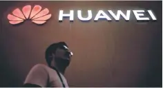 ??  ?? A man walks past a sign board of Huawei. Earlier this year, neighbouri­ng Australia banned Huawei from supplying 5G equipment, also citing security risks. – Reuters photo