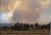  ?? ROBERT BROWMAN — THE ALBUQUERQU­E JOURNAL VIA AP ?? The Calf Canyon/Hermits Peak Fire burns in the hills outside of Las Vegas, N.M., on Saturday.