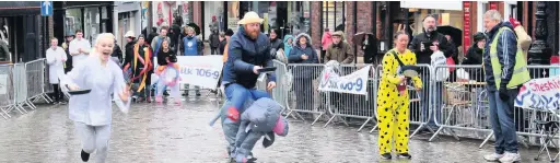  ??  ?? The Macclesfie­ld Pancake Race takes place on Shrove Tuesday