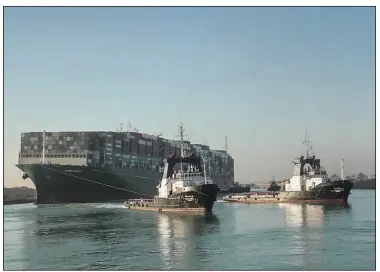  ?? (AP/Suez Canal Authority) ?? The Ever Given, a Panama-flagged cargo ship, is pulled by Suez Canal tugboats March 29.