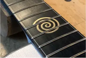  ?? ?? Each fret is painstakin­gly filed to size and checked before being hammered into the guitar’s neck