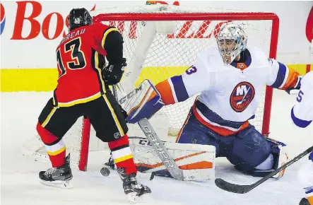  ?? AL CHAREST ?? New York Islanders goaltender Christophe­r Gibson uses his right pad to stop Calgary Flames sniper Johnny Gaudreau for one of his 50 saves in a 5-2 win over Calgary at the Scotiabank Saddledome on Sunday. With the victory, the Islanders snapped an...