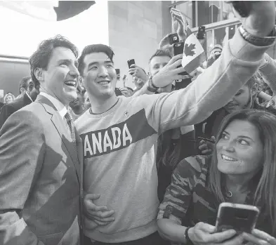  ?? RYAN REMIORZ / THE CANADIAN PRESS FILES ?? Prime Minister Justin Trudeau poses for photos with employees as he leaves the offices of Salesforce earlier this year.