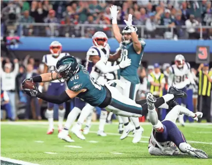  ?? MARK J. REBILAS/USA TODAY SPORTS ?? The Eagles’ Zach Ertz falls into the end zone for the 11-yard winning touchdown catch on a pass from Nick Foles.