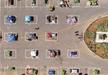  ?? NOAH BERGER/AP ?? Rectangles designed to help prevent the spread of the coronaviru­s by encouragin­g social distancing line a city-sanctioned homeless encampment at San Francisco’s Civic Center on May 21.