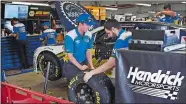  ?? CHARLES KRUPA/AP PHOTO ?? The Hendrick Motorsport­s race crew for Chase Elliott prepares for practice Friday prior to qualifying for the race at New Hampshire Motor Speedway in Loudon, N.H.