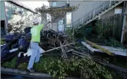  ?? GERALD HERBERT — THE ASSOCIATED PRESS ?? Caleb Cormier moves debris after Hurricane Delta moved through on Saturday, Oct. 10, in Lake Charles, La.