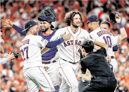  ?? Karen Warren / Staff photograph­er ?? Astros second baseman José Altuve (27) rushes to catcher Robinson Chirinos, starting pitcher Gerrit Cole, center, and first baseman Yuli Gurriel (10) to celebrate after winning Game 5 of the American League Division Series on Thursday.