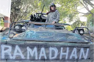  ?? REUTERS ?? A Philippine army soldier stands on a tank inside the city hall compound in Marawi yesterday.