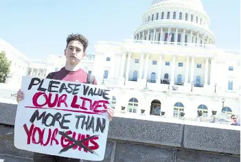  ?? — AFP file photo ?? Amit Dadon, a graduate in 2017 from Marjory Stoneman Douglas High School, poses for a photo on the West Lawn of the US Capitol after rallying with several hundred fellow students to call for stricter gun laws in Washington, DC to protest gun violence.