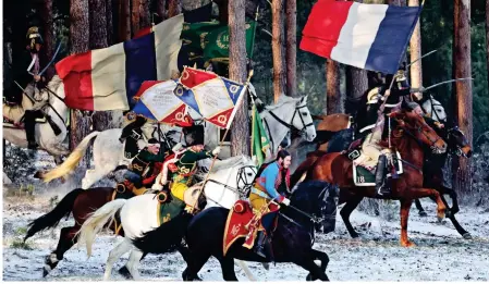  ?? ?? Charge! Cast members, top and above, in Bourne Wood recreate the 1812 French invasion of Russia
