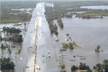  ??  ?? Vehicles on Interstate 10 navigate through flood waters caused by Tropical Storm Harvey in Vidor, Texas.