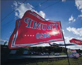  ?? GENE J. PUSKAR — THE ASSOCIATED PRESS ?? Trump campaign banners wave in the wind along Route 8 in Middlesex Township, Pa., in conservati­ve Butler County on Thursday.