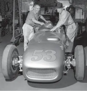  ?? THE COMMERCIAL APPEAL FILES ?? May 5, 1954: Pat Clancy, right, and his mechanic, Barney Wimmer, push the gold and red Pat Clancy Special aboard a truck for a trip to Indianapol­is and Clancy’s seventh try at winning the famed 500-mile. They’ve been working since February to get the powerful car in shape.