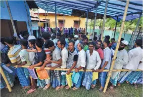  ??  ?? REUTERS People wait in queue to check their names on the draft list at the National Register of Citizens (NRC) center at a village in Nagaon district, Assam state, India, on July 30, 2018.