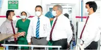  ?? ?? Alumex MD Pramuk Dediwela (center left) and Mabroc Teas MD Niran Ranatunge at the Kiribathgo­da Base Hospital ward that was converted to a COVID-19 highdepend­ency unit