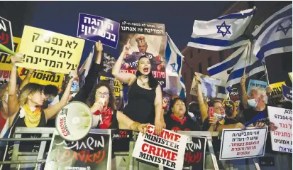  ?? (Marc Israel Sellem/The Jerusalem Post) ?? PEOPLE PROTEST outside the Prime Minister’s Residence in Jerusalem yesterday.