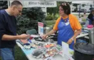  ?? COURTESY — PATTY KISHMAN ?? Ritter Public Library staff member Elizabeth Donaldson displays some items available as Make, Take and Borrow kits collection at Ritter Public Library, 5680 Liberty Ave. in Vermilion.