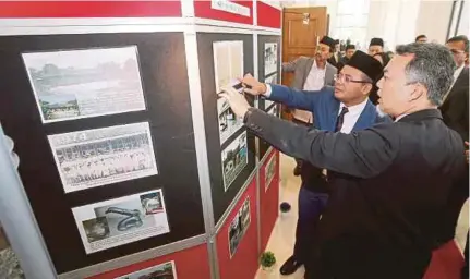  ?? (Foto Sadam Yusoff/bh) ?? Amirudin mendengar penerangan Penyelia Kanan Bahagian Pendidikan Islam JAIS, Yuszaimi Muslil (kanan) ketika melawat pameran pada Konvensyen Transforma­si Pengurusan Hal Ehwal Islam JAIS di Dewan Syarahan dan Muzakarah Islam, di Shah Alam, semalam.