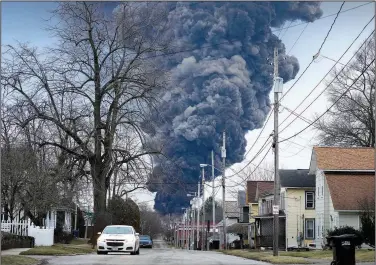  ?? (File Photo/AP/Gene J. Puskar) ?? A black plume rises over East Palestine, Ohio, on Feb. 6 as a result of a controlled detonation of a portion of derailed Norfolk Southern trains. Stories circulatin­g online incorrectl­y claim a video of a purple cloud looming over a street as a car drives underneath shows East Palestine after the derailment and intentiona­l burning of some of the hazardous chemicals on board.