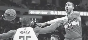  ?? AP ?? The Wizards’ Kyle Kuzma passes the ball in front of the Bucks’ Serge Ibaka on Jan. 1.