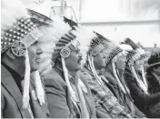  ?? [AP PHOTO] ?? Mourners in full headdress Wednesday attend the funeral of Joe Medicine Crow at the Apsaalooke Veterans Cemetery near Crow Agency, Mont.