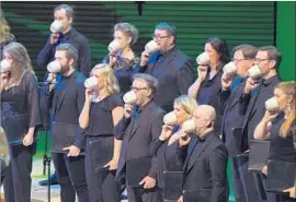  ??  ?? SCHOLA CANTORUM chamber choir sings into teacups to elicit a sound from the past while performing the premiere of Thuridur Jónsdóttir’s “Cylinder 49.”