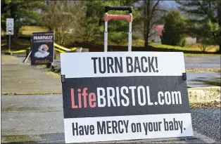  ?? EARL NEIKIRK — THE ASSOCIATED PRESS ?? Anti-abortion signs are displayed outside Bristol Women’s Health Clinic last week in Bristol, Va. Residents in southweste­rn Virginia have battled for months over whether abortion clinics limited by strict laws in other states should be allowed to hop over the border and operate there.