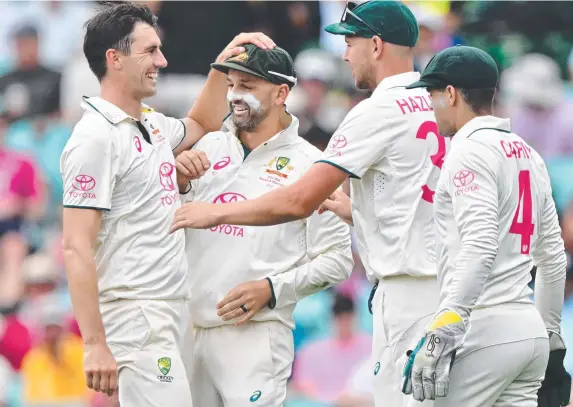  ?? Picture: AFP ?? Aussie skipper Pat Cummins celebrates the wicket of Pakistan’s Sajid Khan with teammates during the first day of the third Test at the SCG.