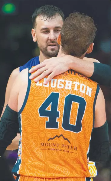  ?? Picture: AAP ?? WELL DONE: Andrew Bogut of the Kings hugs Alex Loughton of the Taipans during the Round 18 NBL match at Qudos Bank Arena in Sydney on Saturday.