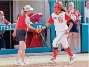  ?? [PHOTO BY SARAH PHIPPS, THE OKLAHOMAN] ?? Oklahoma slugger Jocelyn Alo, right, celebrates a home run with Sooners coach Patty Gasso during a game this season. Alo, a freshman, led the nation with 30 home runs this season.