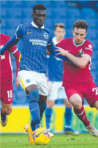  ??  ?? Brighton’s Yves Bissouma and Liverpool’s Diogo Jota clash during yesterday’s Premier League match in Brighton. Picture: MIKE HEWITT/ GETTY