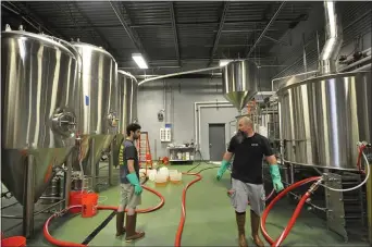  ?? PHOTO COURTESY OF 2SP BREWING COMPANY ?? While still working on beer and canning, Bob Barrarr and Andrew ‘Ruby’ Rubenstein are making sure they social distance while working in the 2SP brewery.