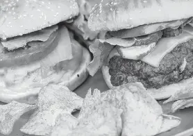  ??  ?? Smoked Onion Cheeseburg­er, left, and Blue Cheese-Stuffed Smoked Burger