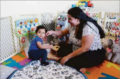  ?? Tyler Sizemore / Hearst Connecticu­t Media ?? Karina Mendez plays with her son, Samuel, 15 months, at their home in Norwalk on Nov. 22.