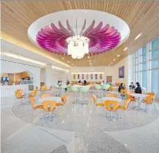  ?? JONATHAN HILLYER PHOTOGRAPH­Y/ PERKINS+ WILL ?? A flower blooms overhead in the dining area at Nemours children’s hospital in Orlando, Fla., with a design theme focused on creating a hospital in a garden.