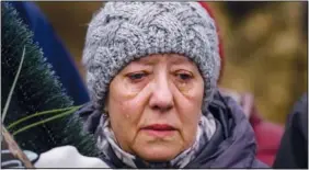  ?? ?? Galina, 64, cries Feb. 21 next to the body of her friend Yurii Kulyk during his funeral in Kalynivka.*