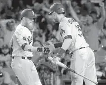  ?? Luis Sinco Los Angeles ?? JUSTIN TURNER, left, is greeted by Cody Bellinger after hitting a fourth-inning home run to cut the Dodgers deficit to 2-1.