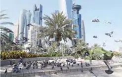  ?? — AFP ?? DOHA: Photo shows pigeons flying above the corniche in Doha. Arab nations including Saudi Arabia and Egypt cut ties with Qatar, accusing it of supporting extremism, in the biggest diplomatic crisis to hit the region in years.