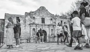  ?? Billy Calzada / Staff file photo ?? Some visitors with masks, and some without, check out the Alamo last month. The city is adding a deadline to design and fund a museum as part of the Alamo Plaza makeover plan.