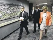  ??  ?? Deputy Secretary of Veterans Affairs Sloan Gibson (left) walks in August past an artist’s rendering of the new VA hospital under constructi­on in Aurora, along with other health officials, at what will be called the Denver VA Medical Center. The VA...