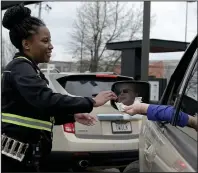  ?? (Arkansas Democrat-Gazette/Stephen Swofford) ?? Sa’mia Moore, assistant team leader, gives change to Melissa Price as Price waits in line Thursday at the Chick-fil-A on West Markham Street in Little Rock.