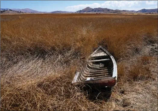  ?? (AP/Juan Karita) ?? An abandoned boat sits near the shore of Lake Titicaca July 27 in Huarina, Bolivia.