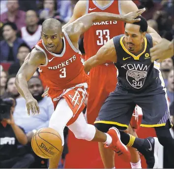  ?? MICHAEL WYKE — ASSOCIATED PRESS ?? Rockets guard Chris Paul steals the ball from Warriors guard Shaun Livingston during Houston’s win last week.