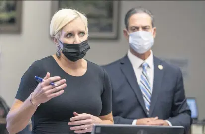  ?? PHOTOS BY LEONARD ORTIZ — STAFF PHOTOGRAPH­ER ?? Senior Deputy District Attorney Whitney Bokosky addresses reporters and community members as Orange County District Attorney Todd Spitzer listens in at the arraignmen­t and bail hearing for Marcus Eriz and Wynne Lee at the Central Justice Center in Santa Ana on Tuesday.