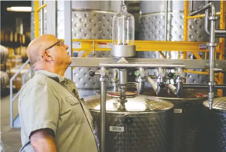  ?? JONAS EKBLOM/REUTERS ?? Herman Mihalich, owner of Mountain Laurel, checks up on the most recent batch of his company’s award-winning rye whiskey. The Pennsylvan­ia craft distillery lost huge sales as its distributo­r halted purchasing its whiskey amid the trade conflict between the U.S. and EU.