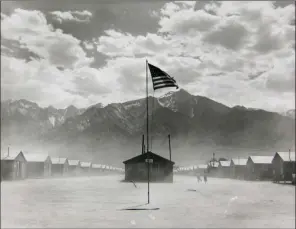  ??  ?? In this 1942 photo taken by Dorothea Lange and provided by the Collection of the Oakland Museum of California, gift of Paul S. Taylor, is Manzanar Relocation Center in Manzanar. AP PHOTO